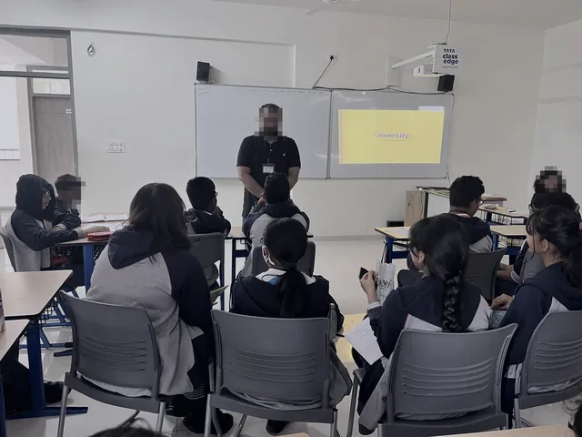 A classroom session with The-Inversity slides on screen